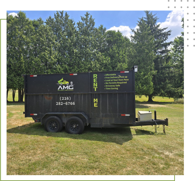 A black trailer with trees in the background