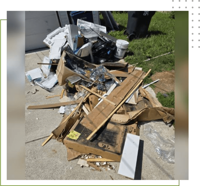 A pile of debris on the ground next to a building.