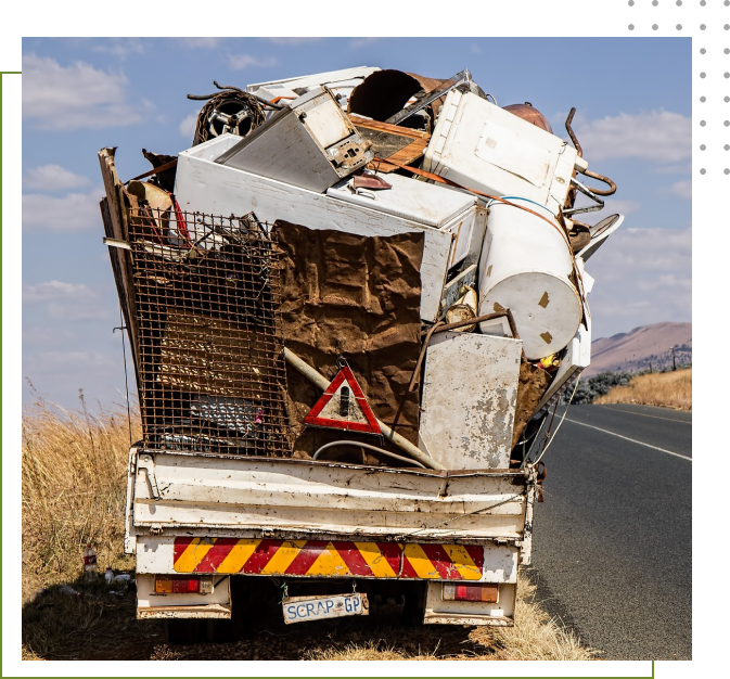 A truck with many junk on the back of it.