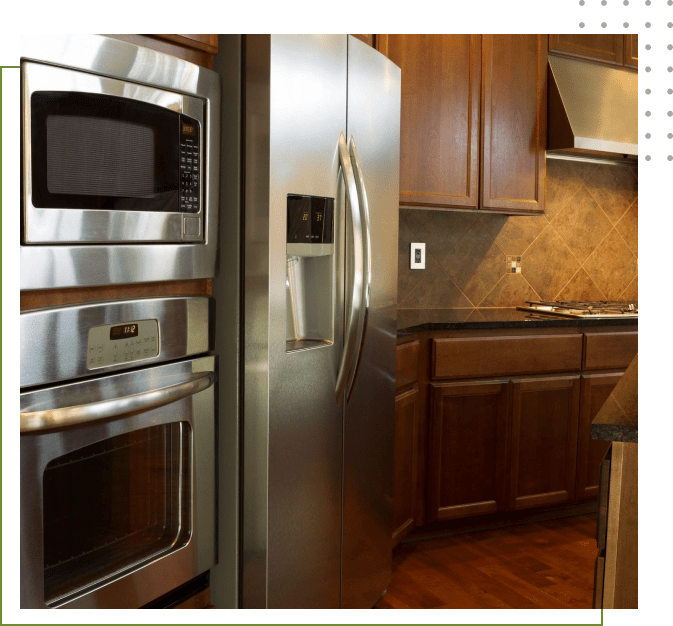 A kitchen with stainless steel appliances and wooden cabinets.