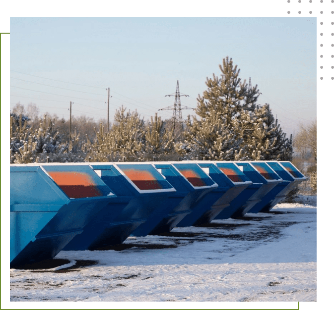 A row of blue and orange bins in the snow.