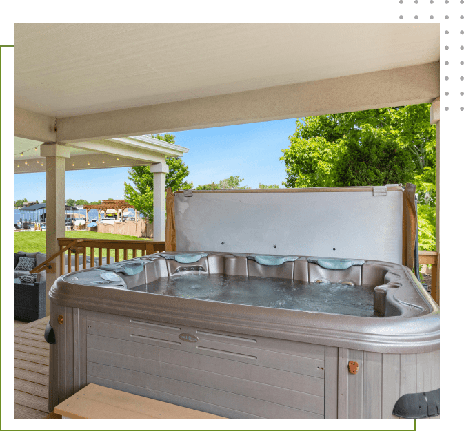 A hot tub is shown in the middle of a deck.