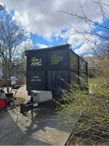 AMG Junk Removal commercial dumpster stationed in a Cleveland neighborhood