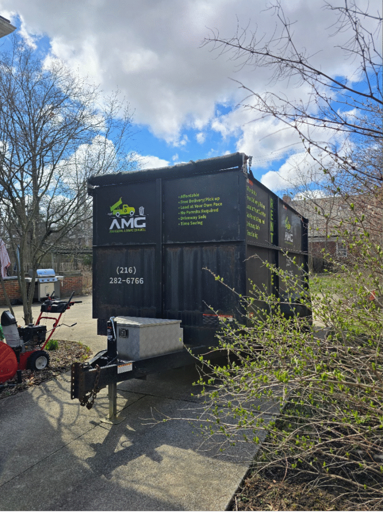 AMG Junk Removal commercial dumpster stationed in a Cleveland neighborhood