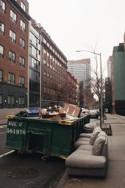 Piles of discarded furniture and trash outside an apartment complex