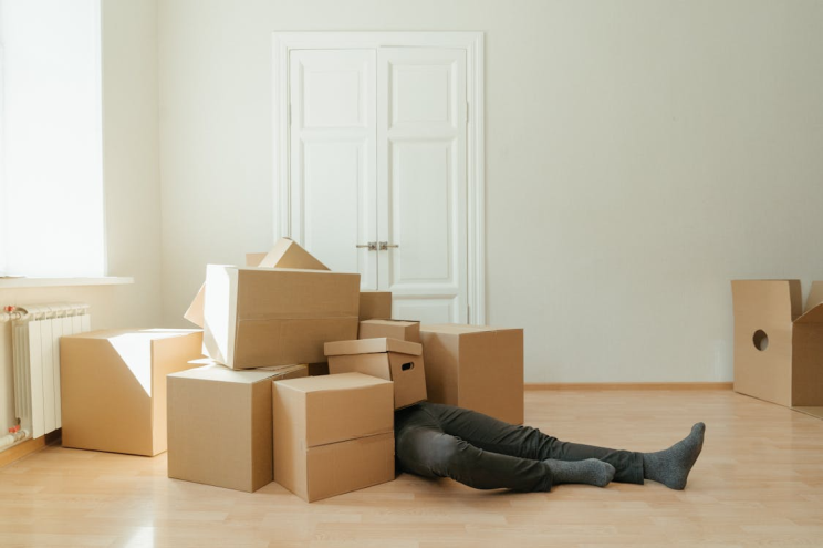 An image of a person under a pile of boxes
