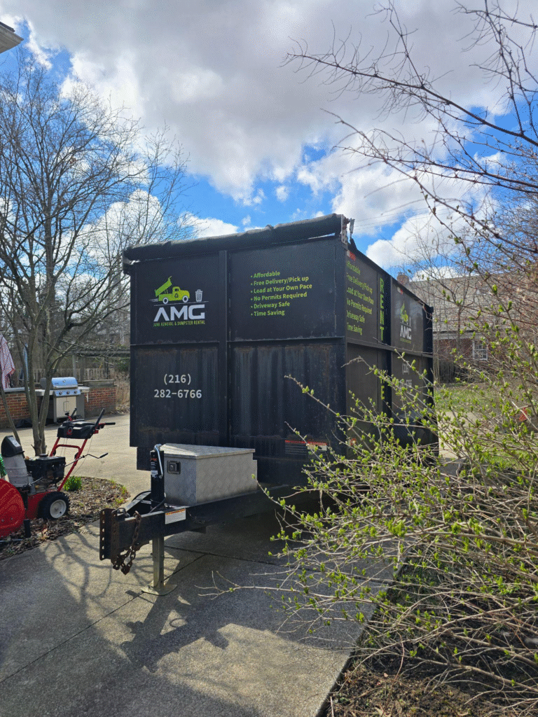 A dumpster on the pavement.
