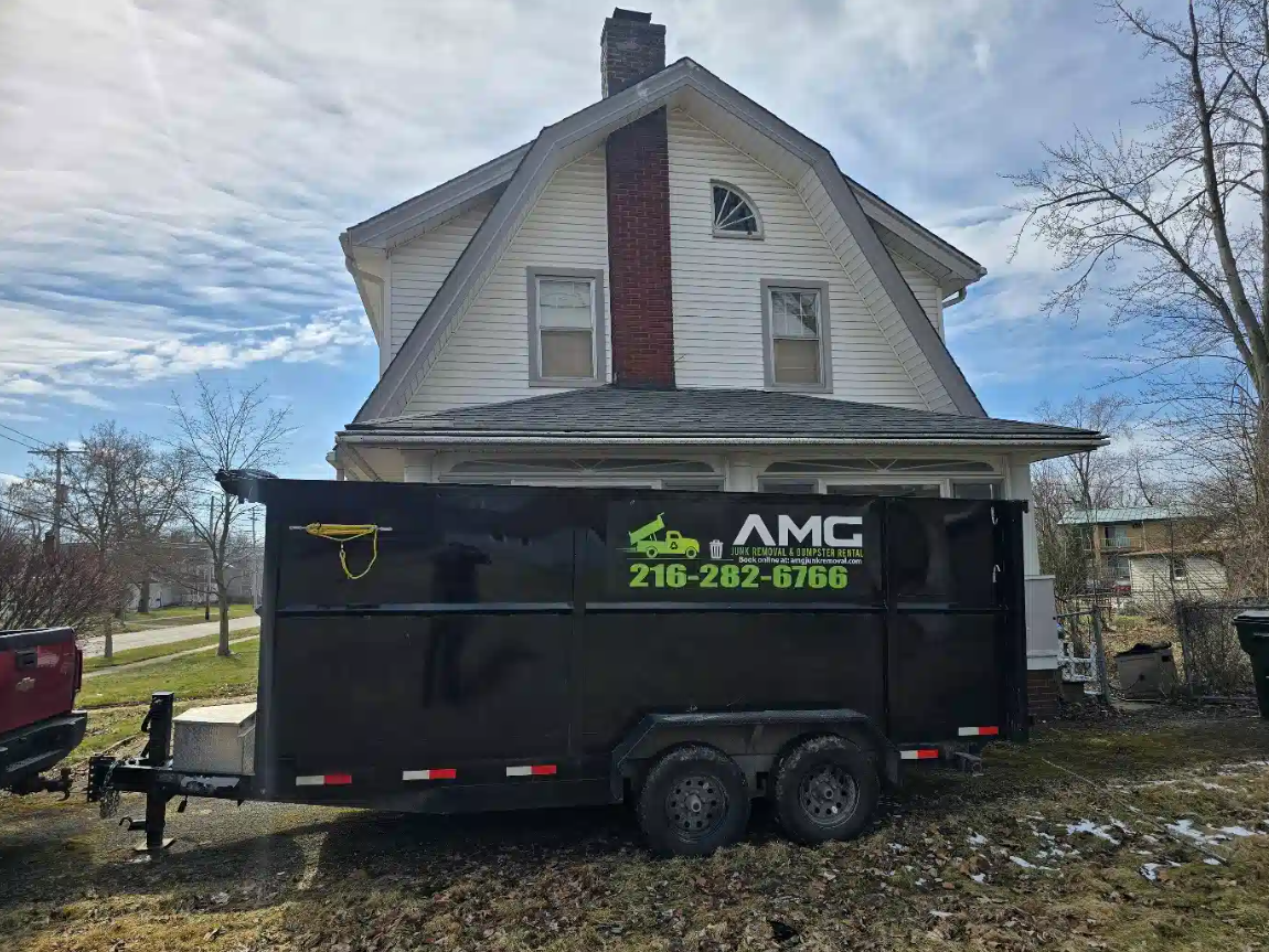 AMG Junk Removal dumpster outside home for hoarder cleanup service.