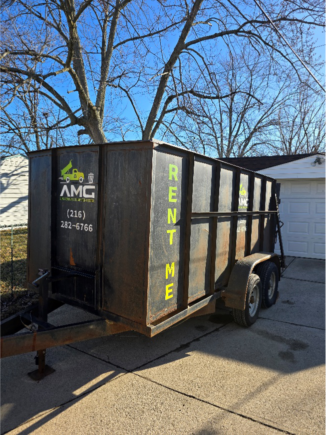 Driveway-safe roll-off dumpster parked outside a suburban home.