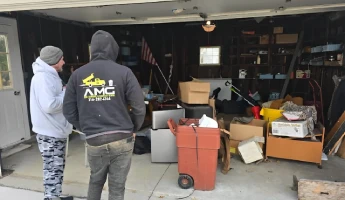AMG Junk Removal crew preparing to clear a garage full of clutter and old appliances in Cleveland.