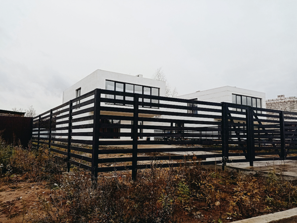 A large black modern fence in the Warrensville Heights neighborhood, illustrating the scale of fence removal projects that require expert equipment.