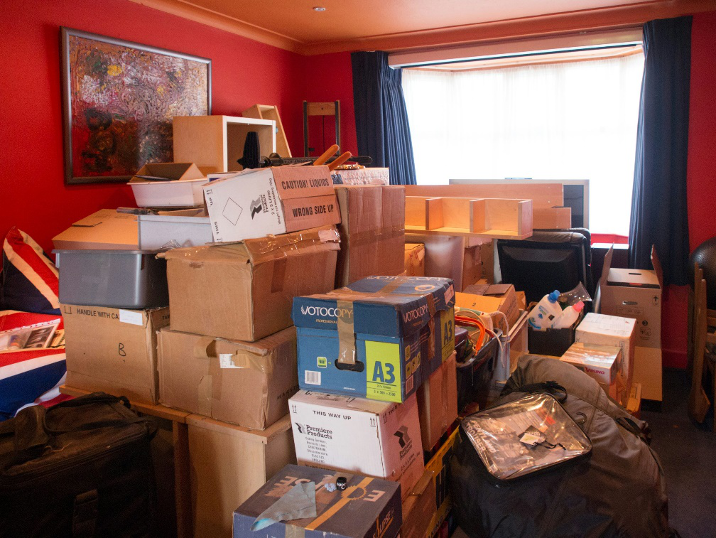 Room filled with boxes, junk, and clutter waiting for residential junk removal service.