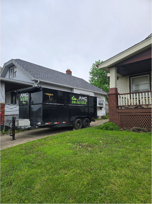  AMG roll-off dumpster rental in Cleveland driveway for home renovation debris.