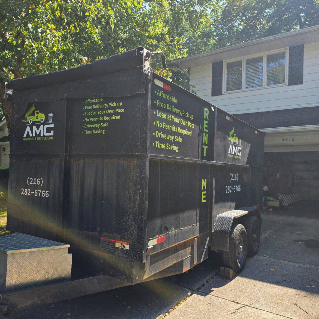 AMG dumpster parked in front of a Cleveland home, ready for eco-friendly junk removal.