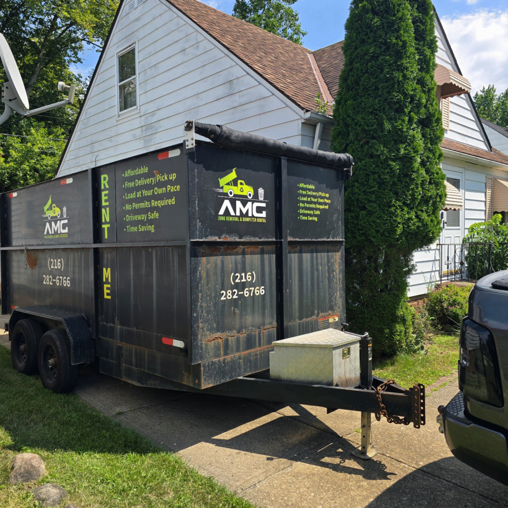 A junk container on a driveway after residential junk removal by AMG in Cleveland