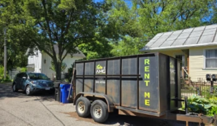 A large junk removal truck parked outside. 